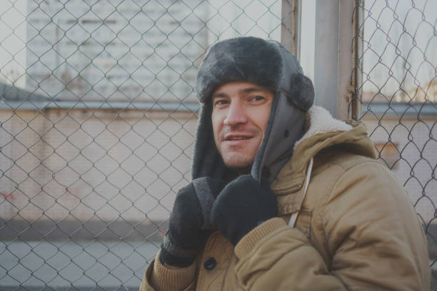 istock Happy handsome young man in cap with earflaps. 1125689356