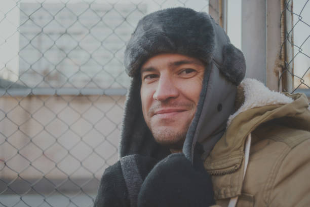 istock Happy handsome young man in cap with earflaps. 1125689387