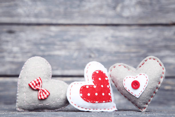istock Fabric hearts on gray wooden table 1125689694