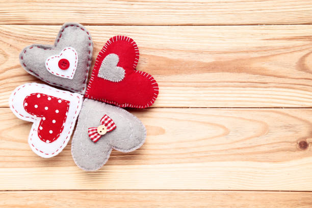 istock Colorful fabric hearts on brown wooden table 1125690372