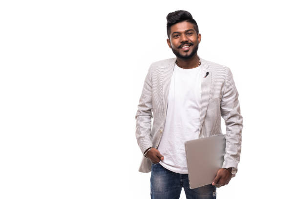 istock Young handsome indian hipster man holding laptop isolated on white background 1125690588