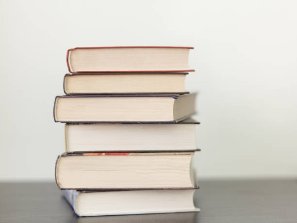 istock a stack of different books in a thick cover on the table 1125691748