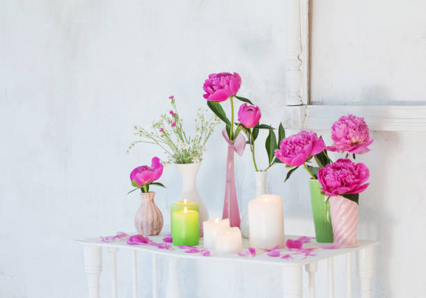 istock flowers in vases and candles on white background 1125692047