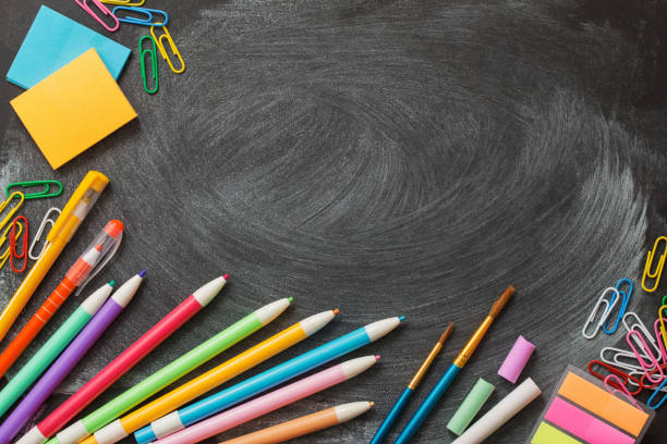 istock school supplies on  blackboard 1125692085