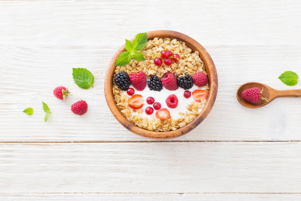 istock granola with berries on white wooden background 1125692179