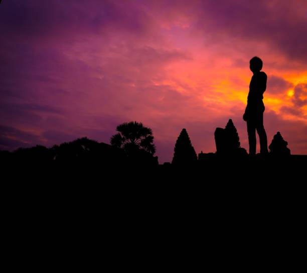A man standing under the dramatic sky