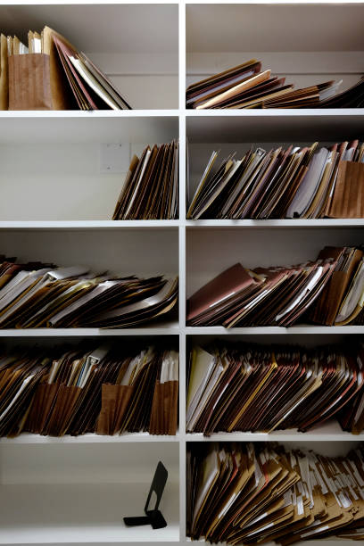 istock Business files in boxes folders and shelf papers 1125692375