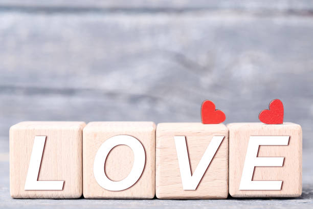 istock Red hearts with wooden blocks on gray background 1125692740