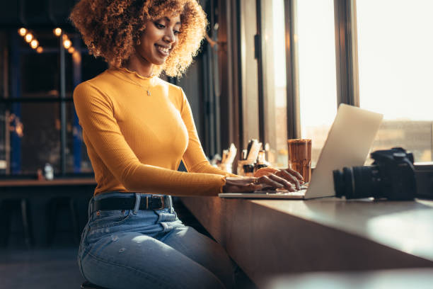 istock Woman working on laptop sitting at a restaurant 1125692957