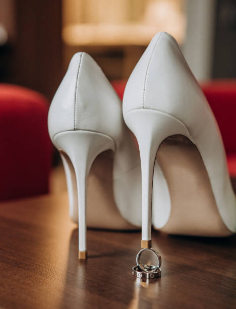 istock gold wedding rings under heel shoes bride 1125694172