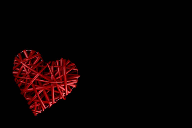 istock Isolated. A red heart woven from a vine on black. Valentine's day 1125694253