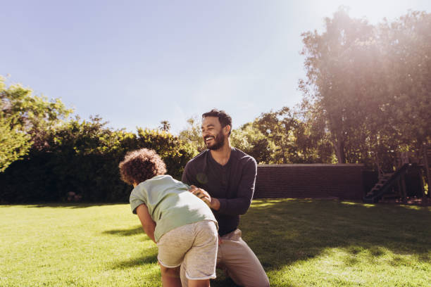 istock Man playing with his son in the park 1125694805