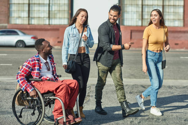 istock Friends walking by disabled man on street 1125697782
