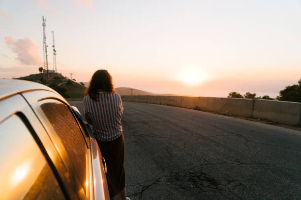 istock Woman looking at Dead Sea at sunset from viewpoint 1125699090
