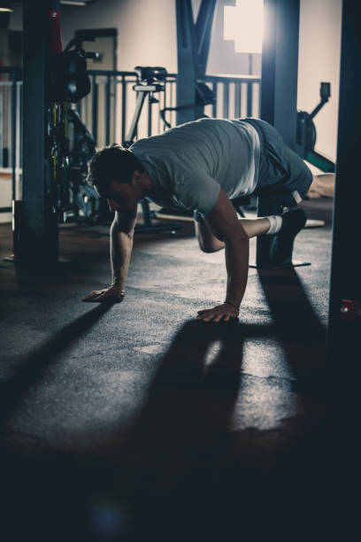 istock Man doing strength workout in the gym 1125700635