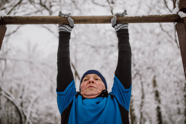 istock Senior man jogging in snow 1125701043