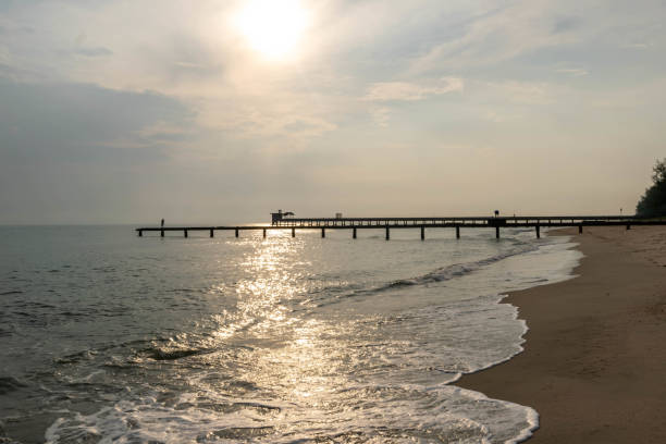 istock Old stone bridge  into the sea. 1125702814