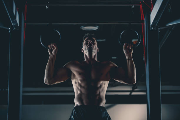 istock Muscular man exercising on gymnastic rings 1125703254