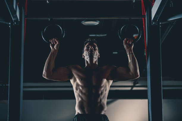 istock Muscular man exercising on gymnastic rings 1125703259