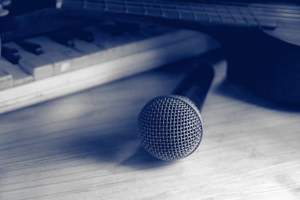 istock Microphone on wooden tables and musical instruments. 1125703345