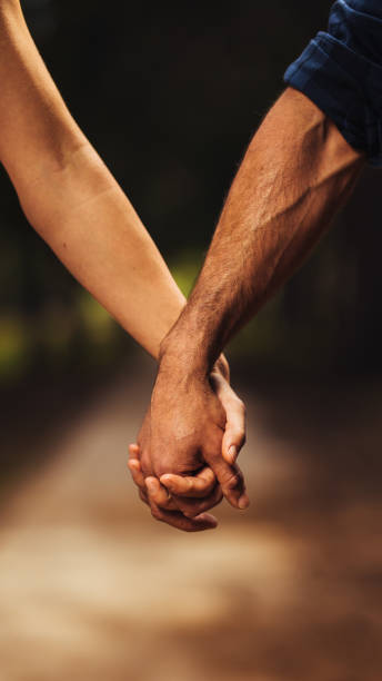 istock Loving couple holding hands in the park 1125703604