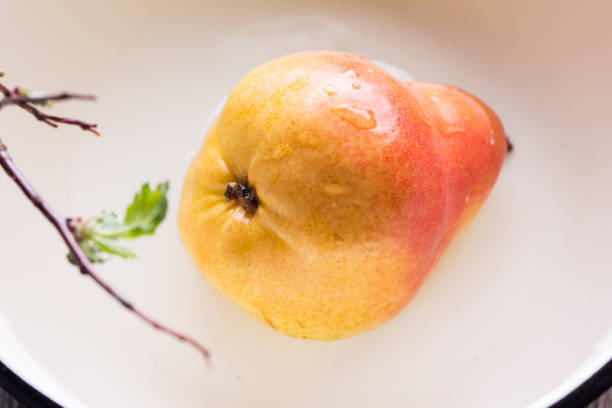 Fresh, sweet pears in a enamel bowl on the table