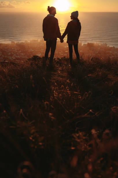 istock Loving couple on mountain peak during sunset 1125703875