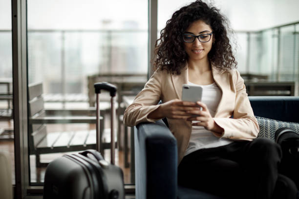 istock Young businesswoman using mobile phone at a cafe 1125703952