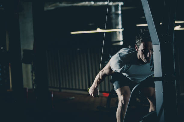 istock Male athlete exercising on cable machine 1125703966