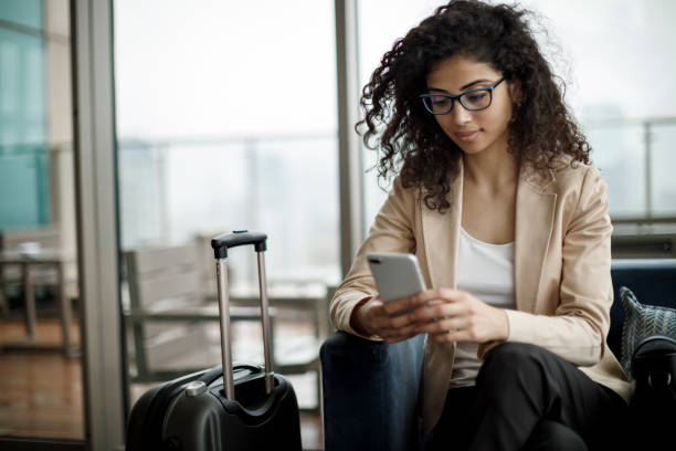 istock Businesswoman using mobile phone at rooftop cafe 1125704043