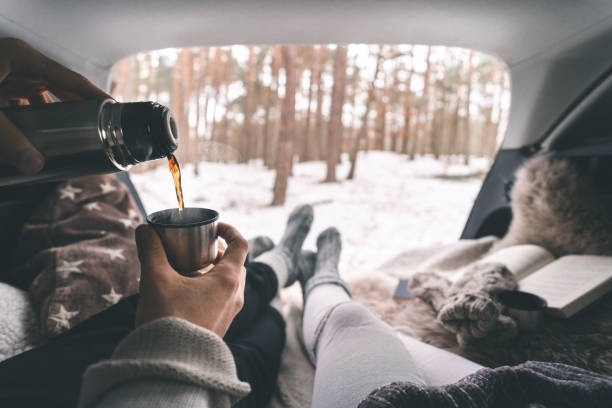 a couple on a winter picnic in their car trunk - people cold frozen unrecognizable person imagens e fotografias de stock