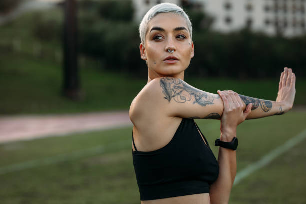 istock Female athlete doing workout stretching her arm 1125705528