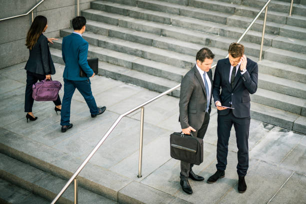 istock Two  businessmen talking on stairs 1125707316