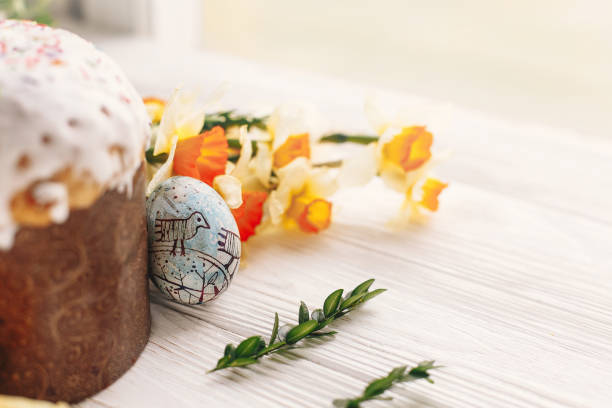 istock happy Easter concept. stylish painted eggs and easter cake on white rustic wooden background with spring flowers. seasons greetings card. space for text. modern easter image 1125709764