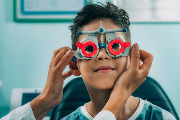 istock Smiling Ophthalmologist Doing Eye Test Of Boy 1125710642