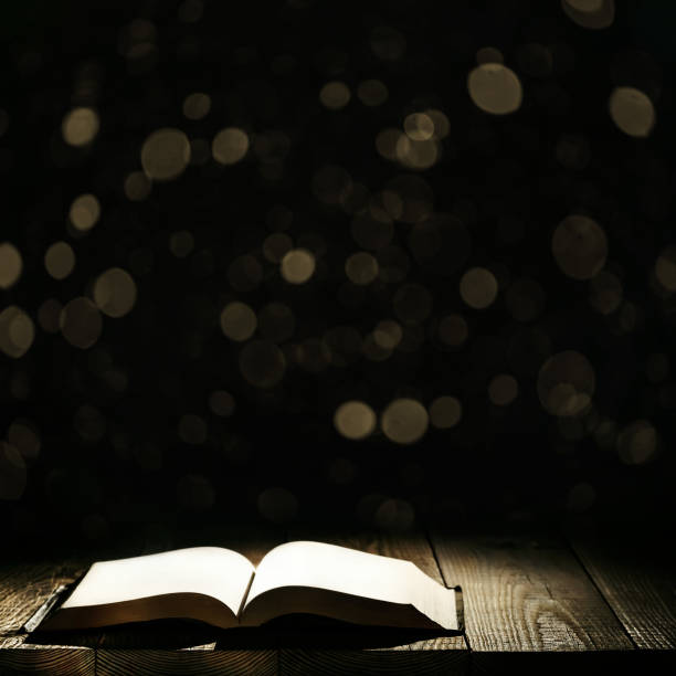 istock book against a moonlight night city 1125712479