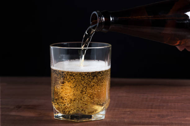 istock light beer in a glass on a wooden table 1125712645