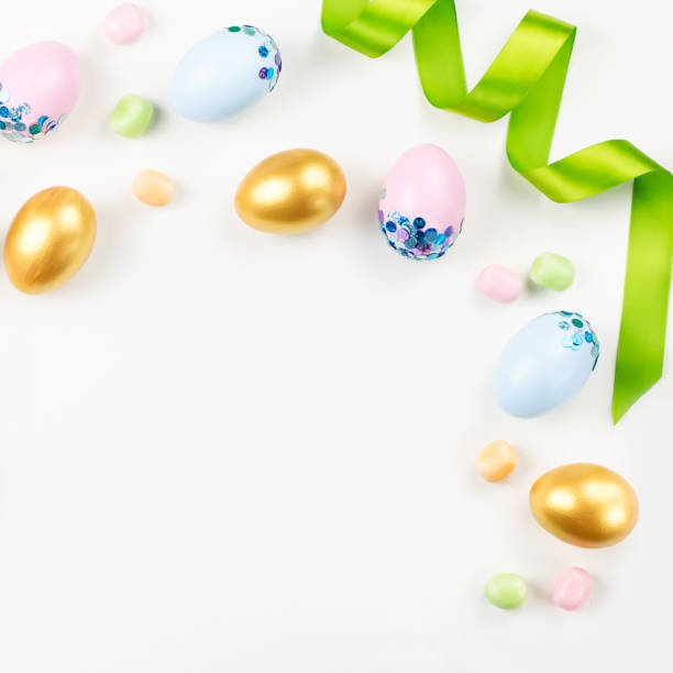 istock Festive Easter background with decorated eggs, flowers, candy and ribbons in pastel colors on white. Copy space 1125715622