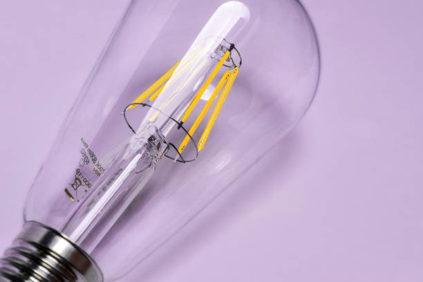 A transparent light bulb placed on a uniform background stock photo