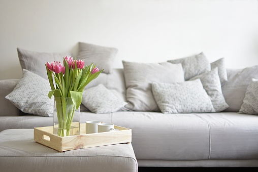 bouquet of tulips on a tray and in the background with sofa