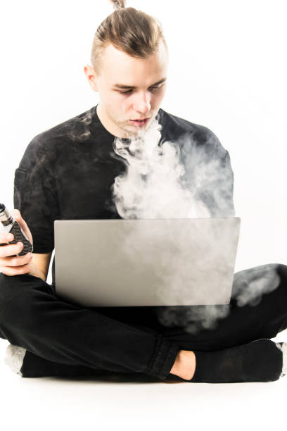 istock man working on laptop and smoking electronic cigarette 1125717879