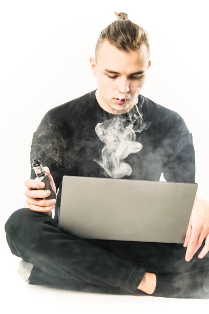 istock man working on laptop and smoking electronic cigarette 1125717980