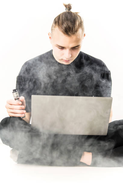 istock man working on laptop and smoking electronic cigarette 1125718079