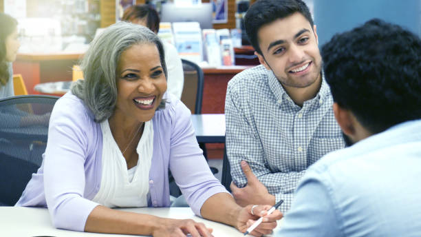 istock Mature businesswoman discusses document with client 1125718936