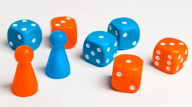 Pawns and colored dice for board games stock photo