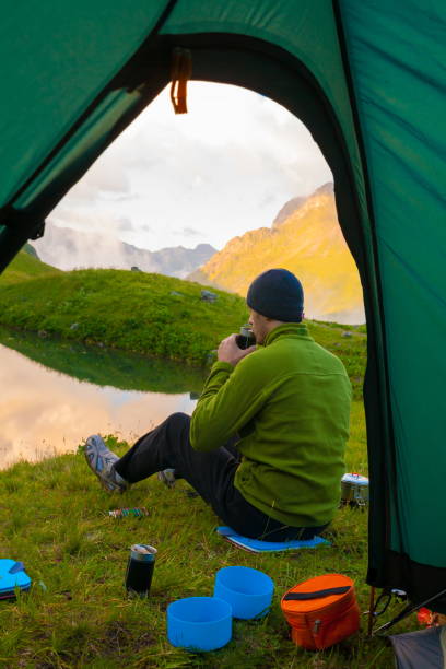 istock A man in mountain day summer. View from tent 1125721373