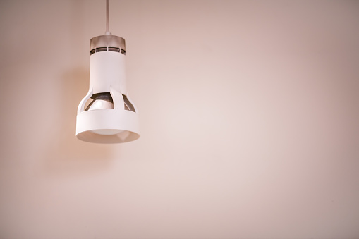 Una blanco moderna lámpara colgante con una pared en el fondo photo