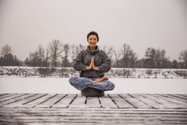 istock Woman meditates on the lake 1125724305