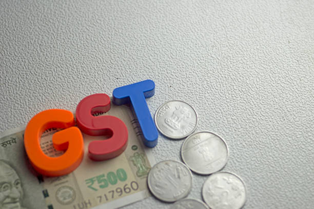 Goods and Services Tax India GST words on white textured background rupee coin stock pictures, royalty-free photos & images