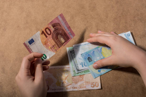 istock Hand holding American dollar  isolated on wooden background 1125727996